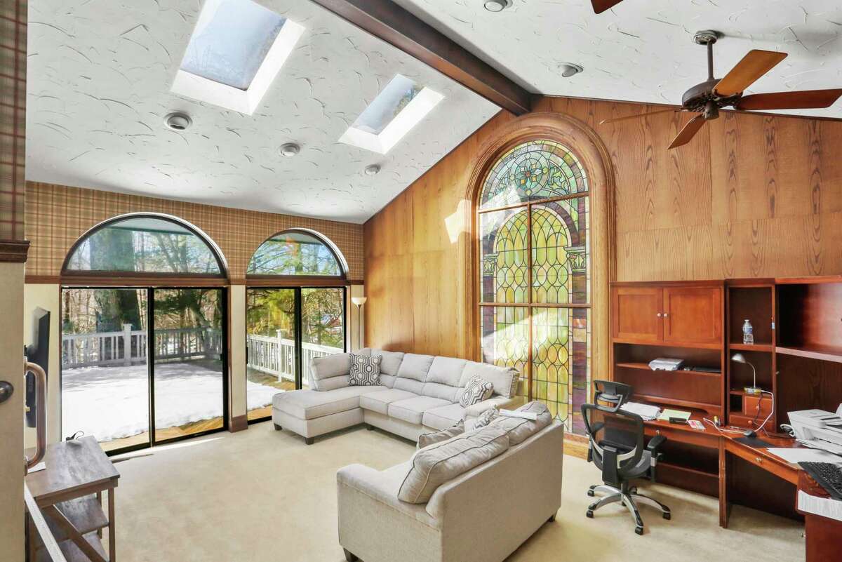 Tall stained glass window in the family room at 3 Sweetbriar Trail, Easton.