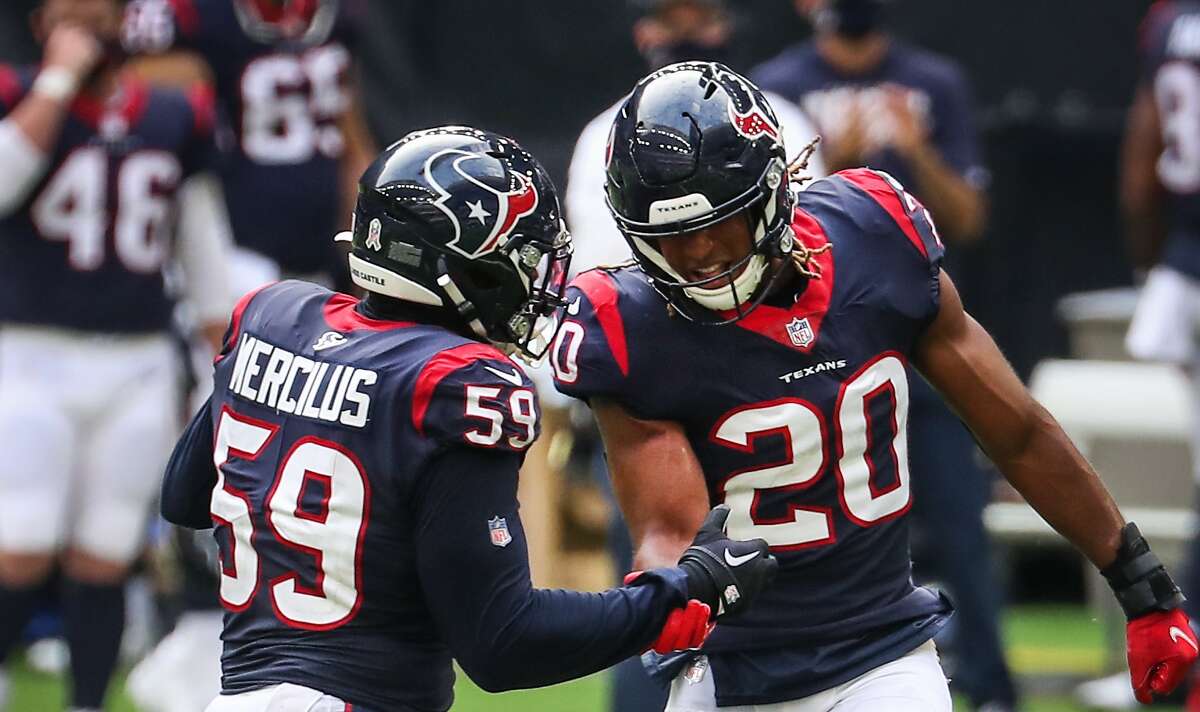 Houston Texans strong safety Justin Reid (20) and outside linebacker Whitney Mercilus (59) celebrate after Reid sacked New England Patriots quarterback Cam Newton (1) during the fourth quarter of an NFL football game at NRG Stadium on Sunday, Nov. 22, 2020, in Houston.