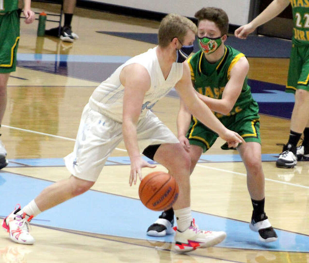 CJ Brunaugh of Jersey, left, scored 11 points for the Panthers in Tuesday night’s 42-39 Mississippi Valley Conference loss to Highland at Havens Gym. He is shown in action earlier this season against Southwestern.