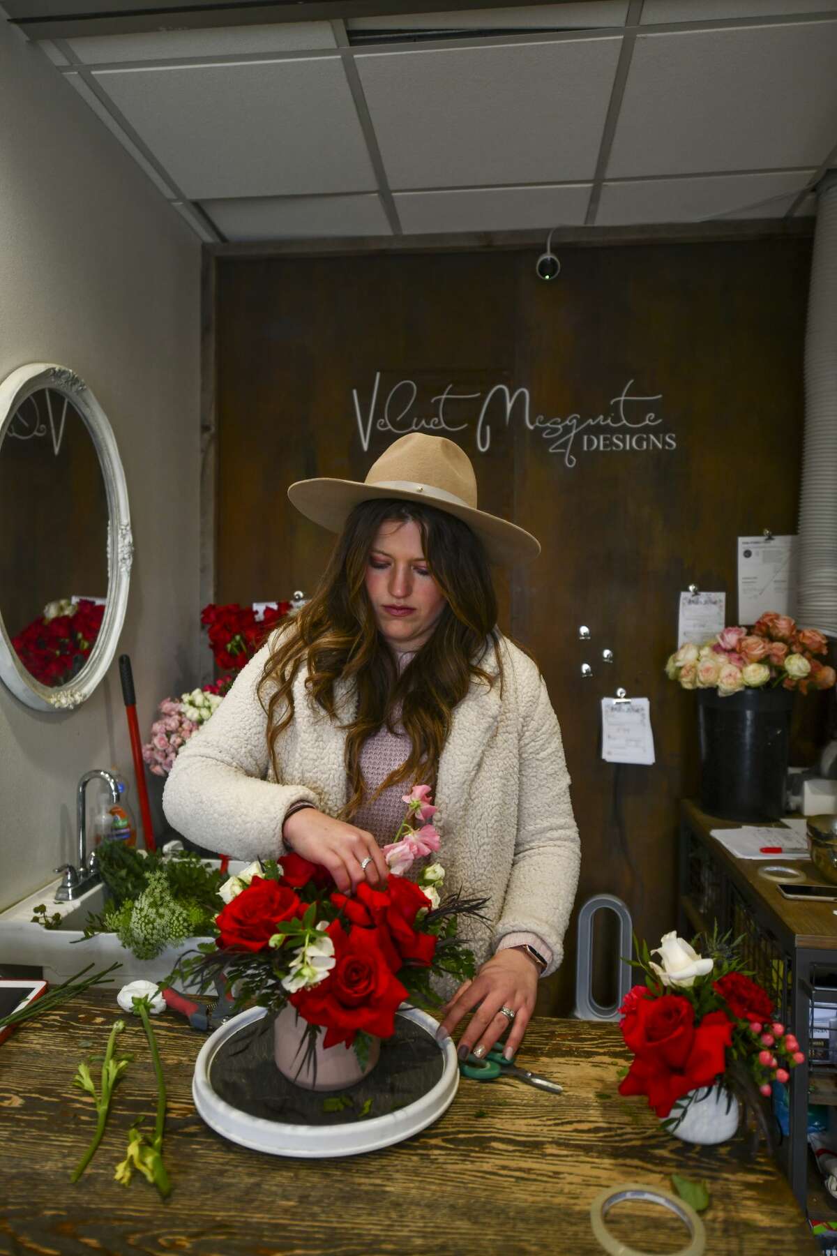 Elizabeth Resch, owner of Velvet Mesquite Designs, creates flower arrangements Thursday, Feb. 11, 2021 at 201 W. Wall St. Suite 107.