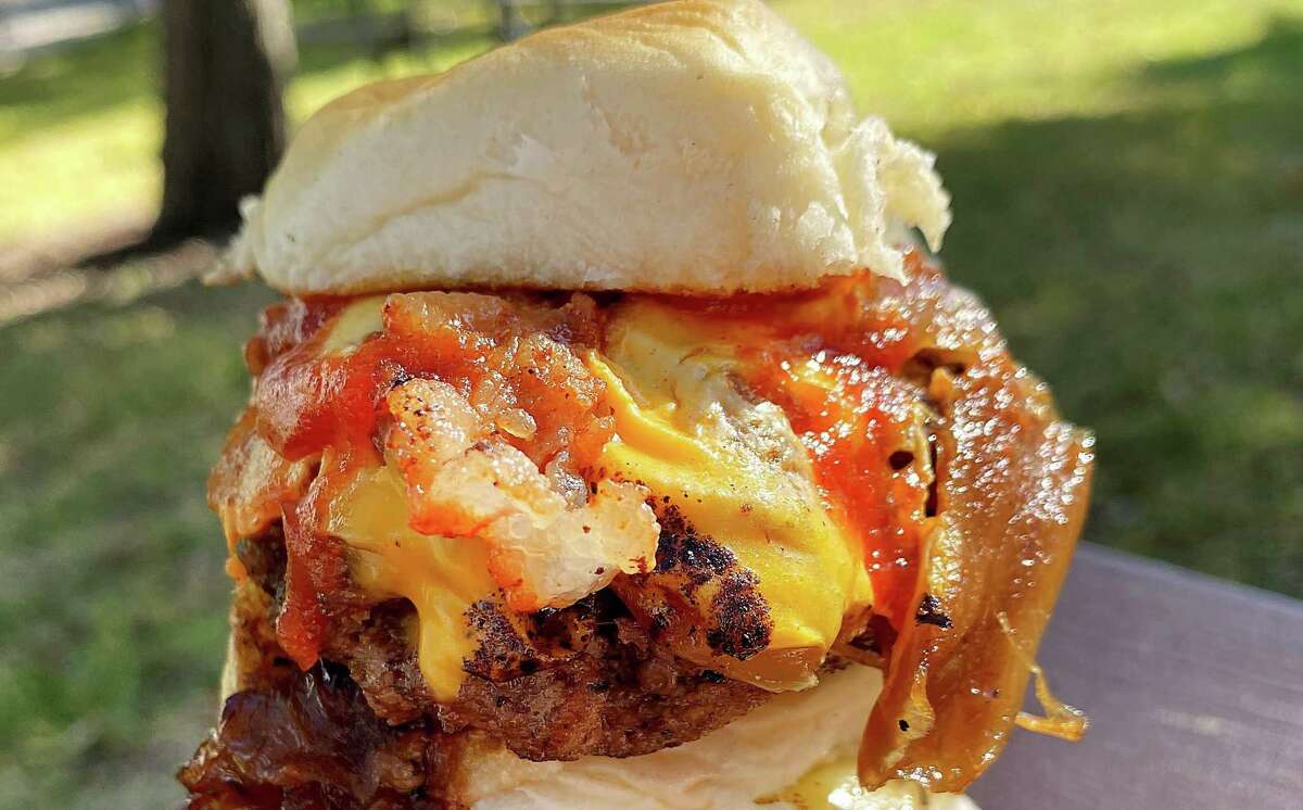 The Chuck Norris kicks it with bacon, American cheese, grilled onions and Sriracha ketchup.