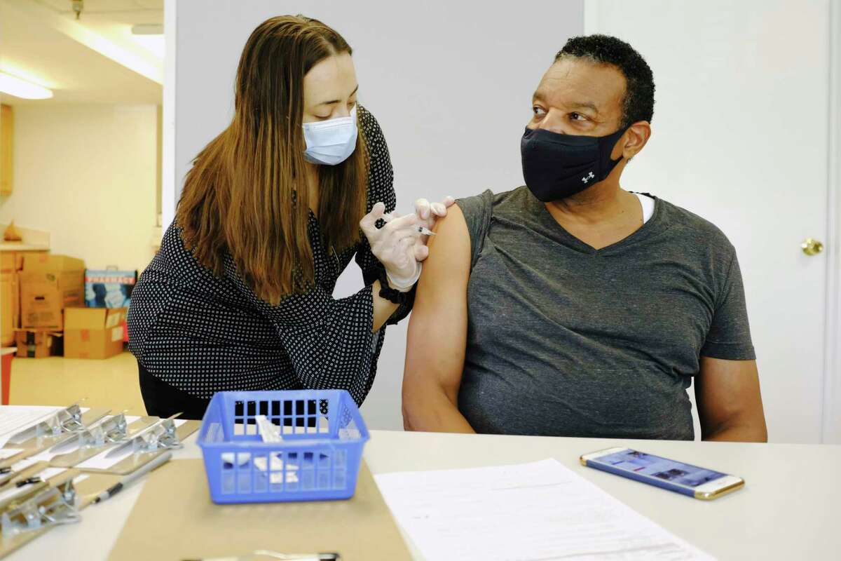 Steve Anthony, right, receives his second dose of the Moderna Covid-19 vaccine from Laura Ordway, the public health pharmacist at The Collaboratory, Albany College of Pharmacy and Health Sciences, on Wednesday, March 10, 2021, in Albany, N.Y. (Paul Buckowski/Times Union)