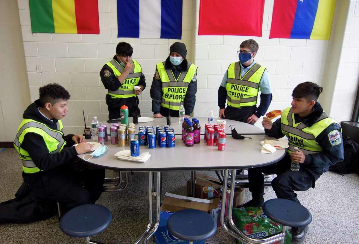 Danbury Police Explorers, who were brought in to help assist, take a lunch break during a Moderna COVID-19 vaccination clinic for Danbury teachers and school district staff at Rogers Park Middle School in Danbury, Conn., on Saturday Mar. 6, 2021. Over 900 teachers and staff received the Moderna vaccine during the two-day clinic.