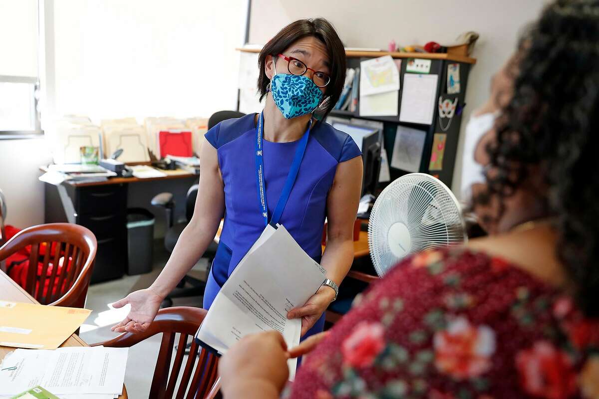Dr. Erica Pan, state epidemiologist and former Alameda County health officer, chats with an administrative assistant in her Oakland office last year.