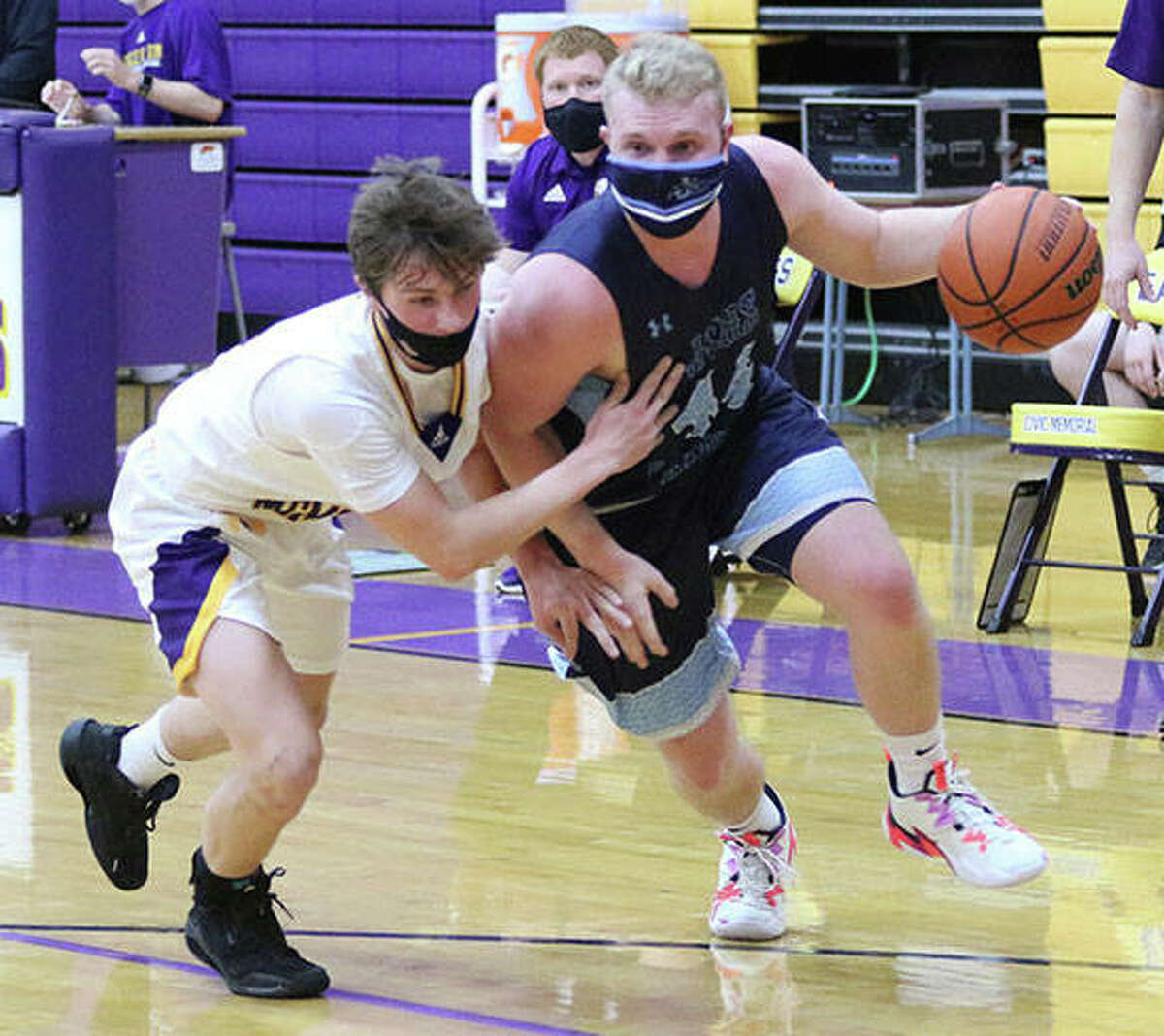 Jersey’s C.J. Brunaugh (right) powers past CM’s Dathan Greene on a drive to the basket in the first half of a Mississippi Valley Conference boys basketball game on Monday night in Bethalto.