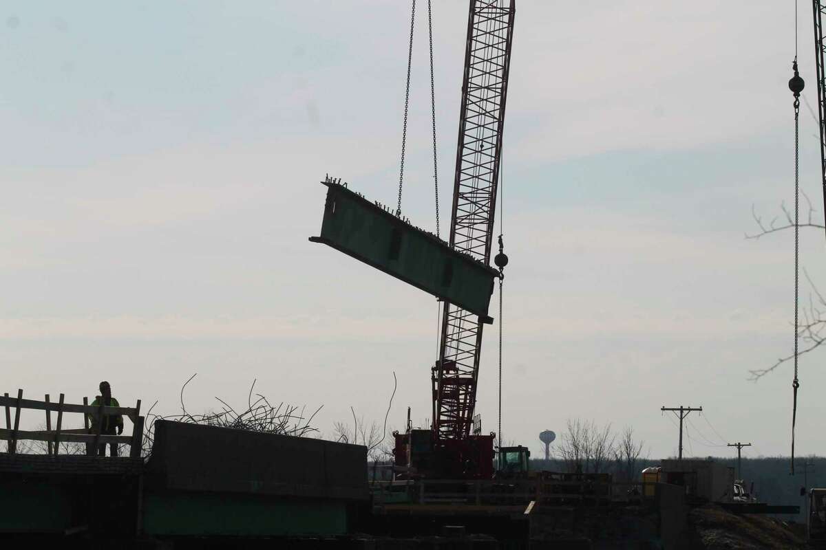 Work continues on the M-55 bridge in Manistee on Monday. Sections of the old bridge are being removed while new bridge piers are being built. (Kyle Kotecki/News Advocate)