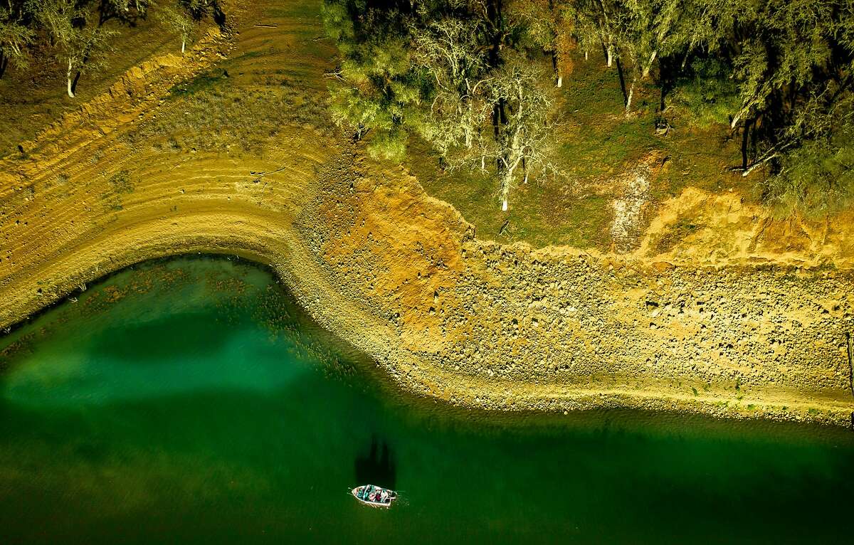 Two men fish near Pleasure Cove Marina at Lake Berryessa earlies this month.