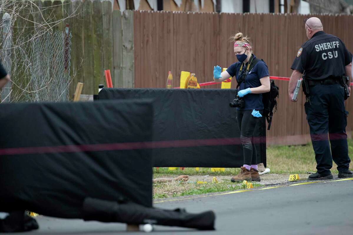 Sheriff's and medical examiner's investigators investigate the scene where two men were shot to death in northeast Harris County Wednesday, March 10, 2021 in Houston. Harris County Sheriff Ed Gonzalez said that a man was eating while sitting in his car in the 4500 block of Shelton, when he was approached by two men who tried to rob him. The sheriff said that the man then pulled out a gun and shot the two men trying to rob him. He then tried to flee in his car, crashing it into a ditch. He got out of his car and took the vehicle of the men trying to rob him. He drove to his father's house, who convinced him to return to the scene and cooperate with sheriff's investigators. The sheriff said investigators will forward their information to the district attorney's office, who will decide on whether charges will be filed.