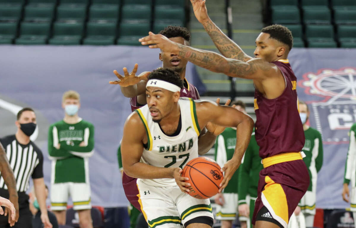 Jalen Pickett of Siena looks to get away from a pair of Iona defenders during their MAAC Tournament quarterfinal Wednesday at Boardwalk Hall in Atlantic City, N.J. Pickett has decided to move on from Siena and entered the NCAA transfer portal.