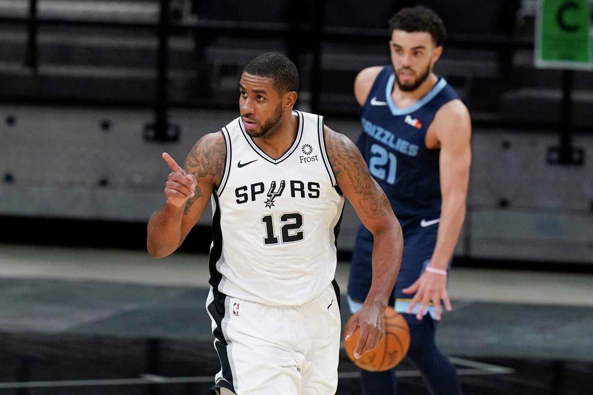 San Antonio Spurs center LaMarcus Aldridge (12) reacts after scoring against the Memphis Grizzlies during the first half of an NBA basketball game in San Antonio, Monday, Feb. 1, 2021. (AP Photo/Eric Gay)