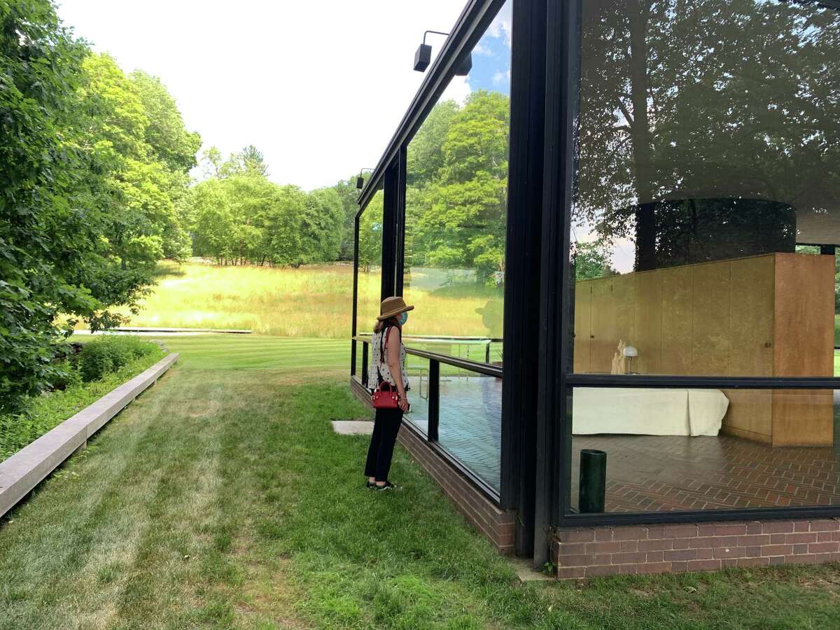 Noelle Newelle peers into the Glass House in New Canaan, which will be opening after the Planning and Zoning Commission approved their plans. Photo was contributed March 2021.