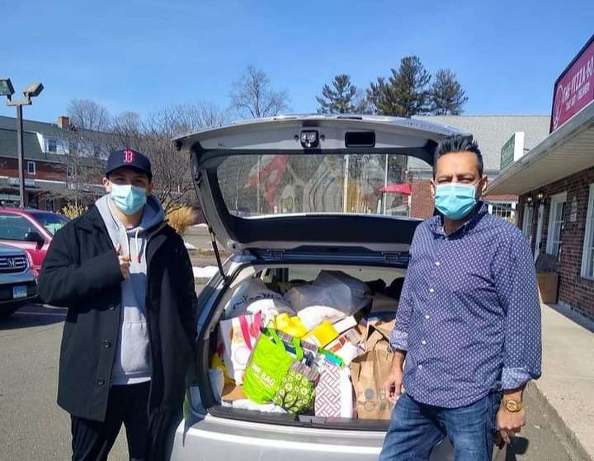 Envision Shelton member Matt McGee, left, and Alderman David Gidwani delivered donated items to Spooner House Monday, March 8. Envision Shelton set up a donation collection box outside Sassafras in early March.