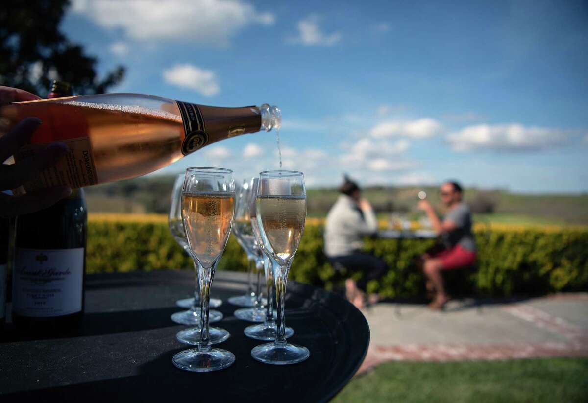 Visitors taste wine at Domaine Carneros winery in Napa on March 5.