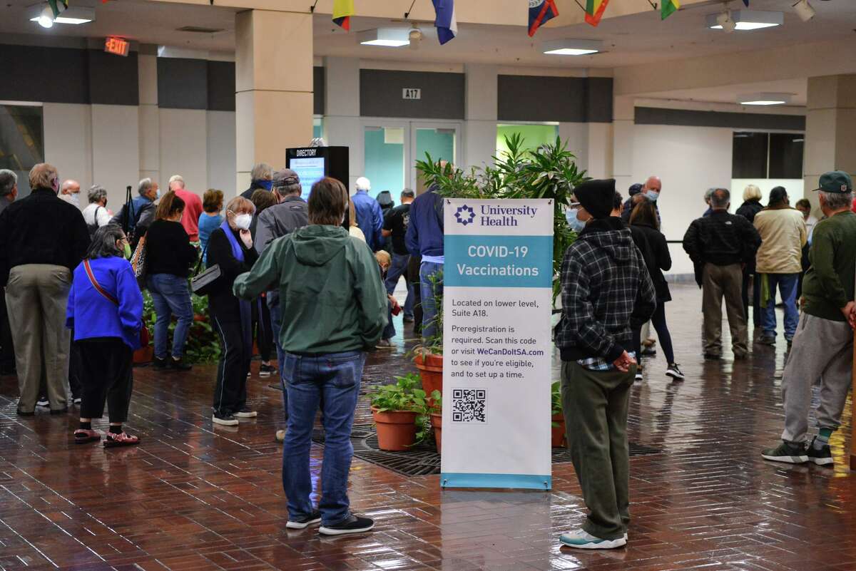 A large group of people wait, without appointments, for the possibility that there would be COVID-19 vaccine available after people with appointments had finished at University Health's Wonderlands of the America's location in March. On Monday, April 19, University Health announced that it had opened the vaccine to walk-ins.