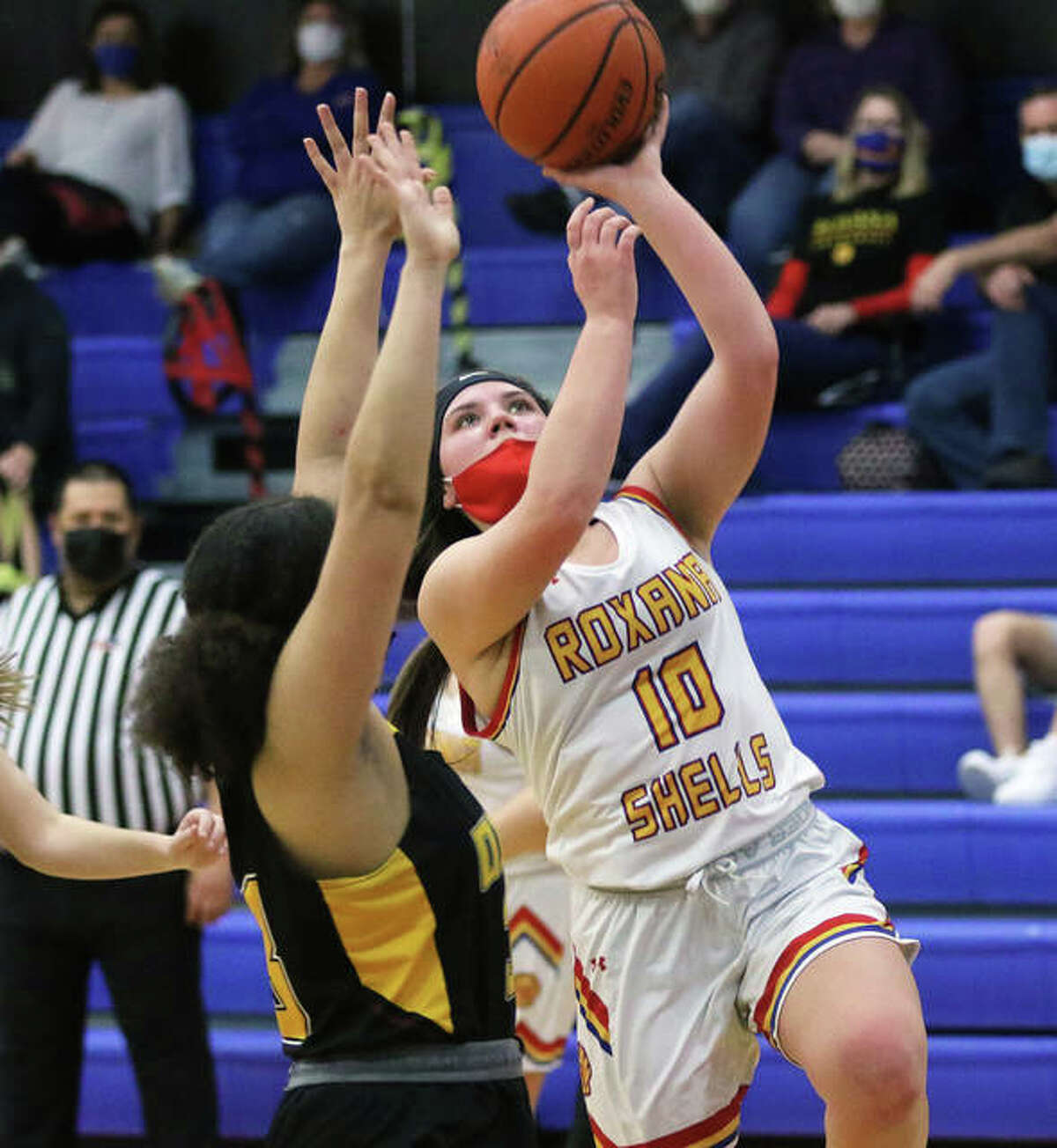 Roxana freshman Kinsely Mouser (10) scores over EA-WR freshman Emily Johnson for two of her 10 points in the second quarter Thursday night in Roxana.