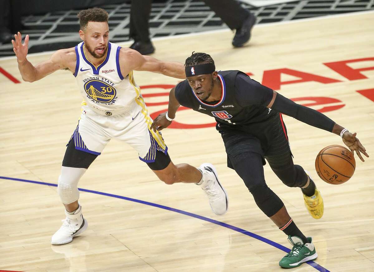 Reggie Jackson of the LA Clippers handles the ball guarded by Stephen Curry of the Golden State Warriors on March 11, 2021.