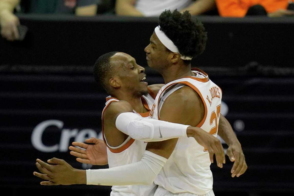 Matt Coleman III, left, Kai Jones and UT will face either Baylor or Oklahoma St. today for the Big 12 title. The Horns were to play Kansas on Friday, but a COVID outbreak sidelined the Jayhawks.