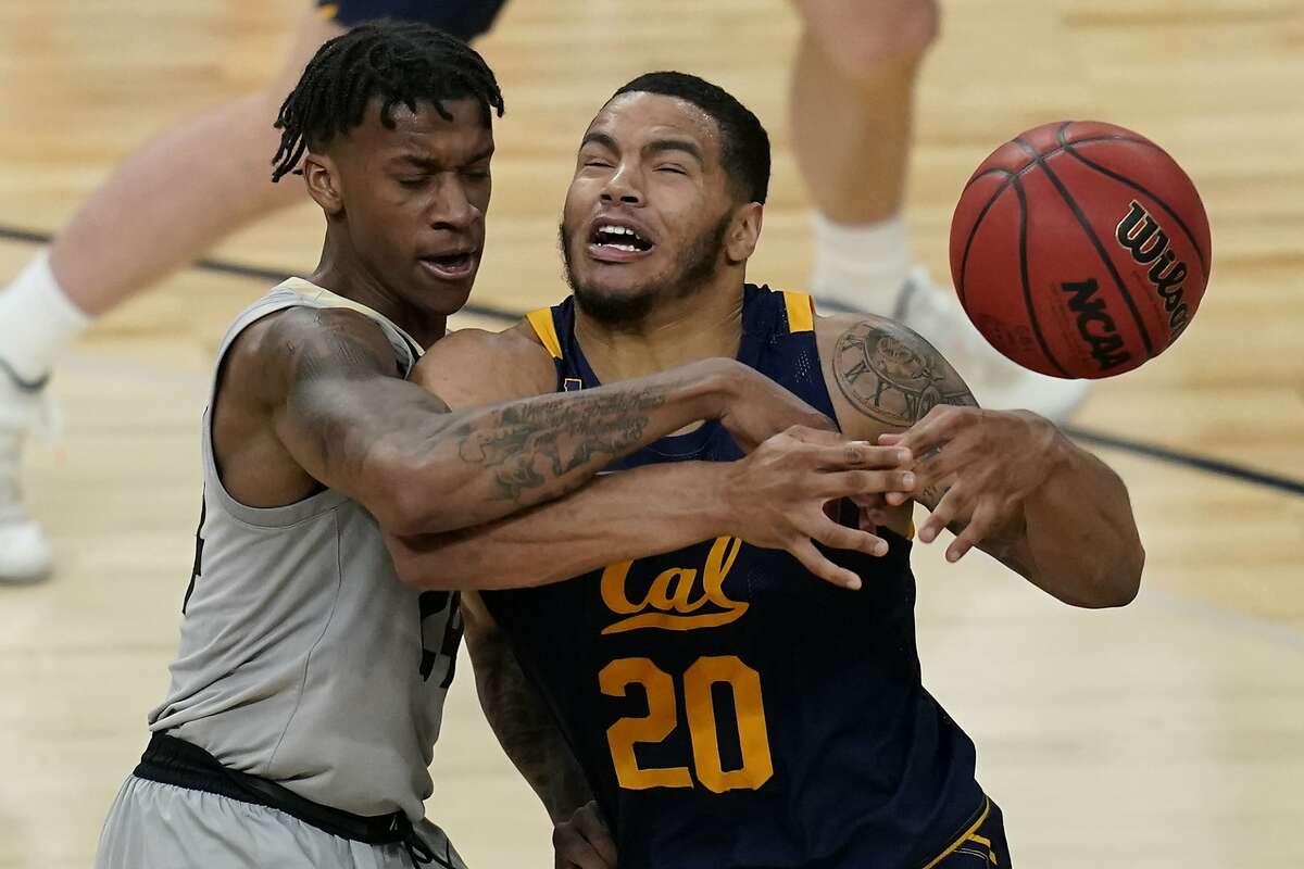 California's Matt Bradley (20) drives into Colorado's Eli Parquet (24) during the first half of an NCAA college basketball game in the quarterfinal round of the Pac-12 men's tournament Thursday, March 11, 2021, in Las Vegas. (AP Photo/John Locher)