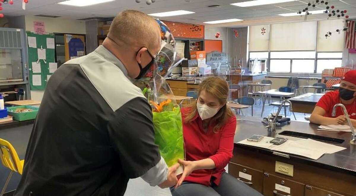 Stamford High School teacher Donna Kaiser receives a gift from Stamford High Principal Ray Manka after being named the district’s teacher of the year.