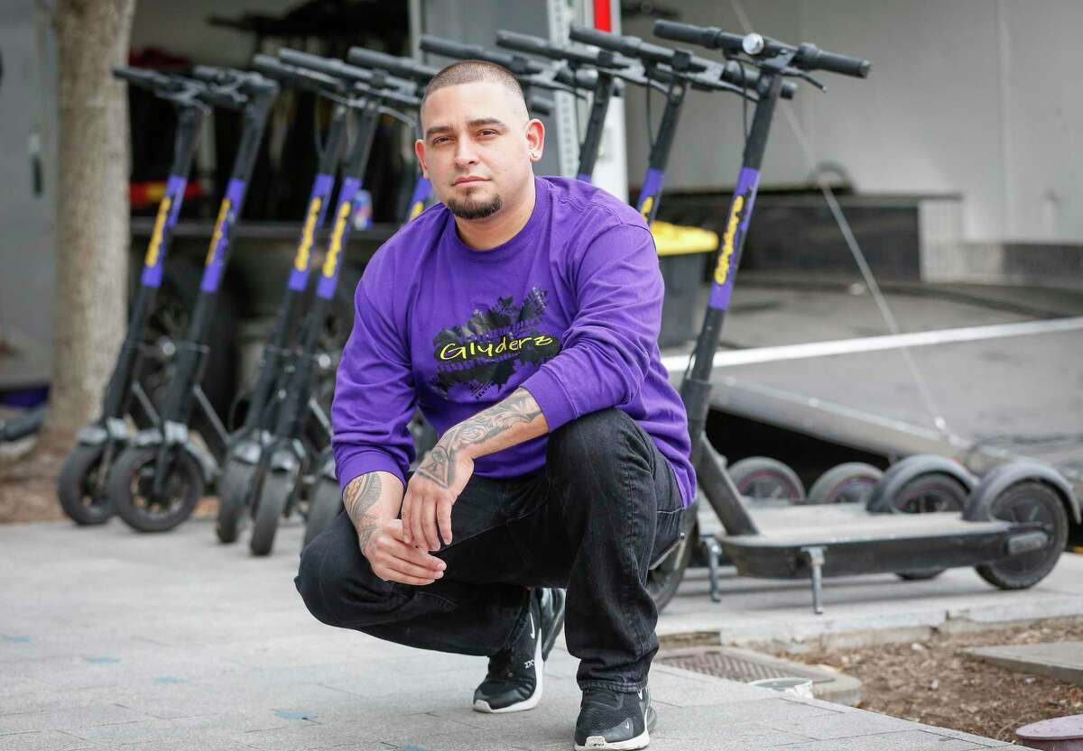 Juan Valentine, owner of Glyderz Houston, poses in front of his popup scooter rental business on March 9, 2021, in Houston. City officials on March 24 banned rental of scooters along public sidewalks.