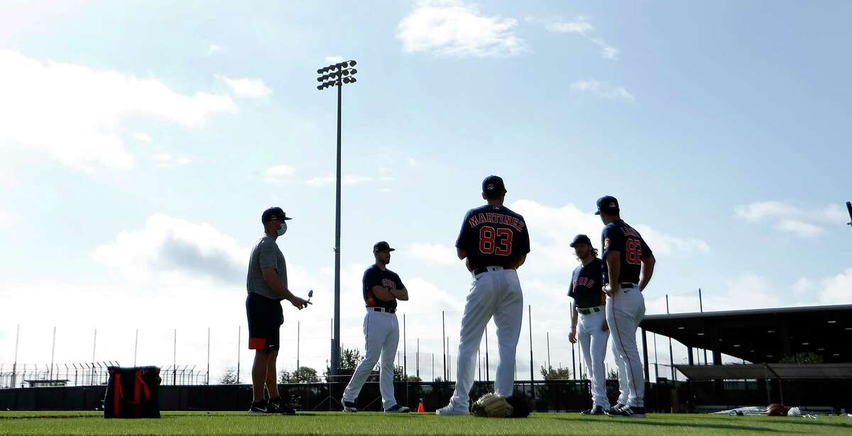 Houston Astros pitchers stand on the field during the second day of full-squad workouts for the Astros at Ballpark of the Palm Beaches in West Palm Beach, Florida, Tuesday, February 23, 2021.
