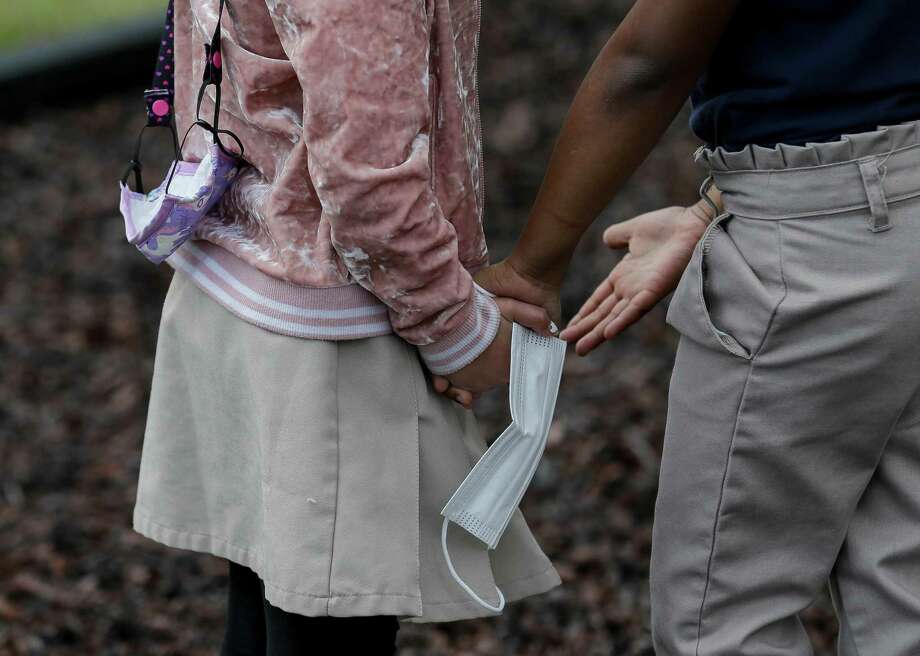 Kindergartners Aubrey Martinez and Skyla Allen hold hands as they play in the playground at Creative Corner Child Development Center on Tuesday, March 9, 2021, in Houston. Photo: Godofredo A. Vásquez, Houston Chronicle / Staff Photographer / © 2021 Houston Chronicle