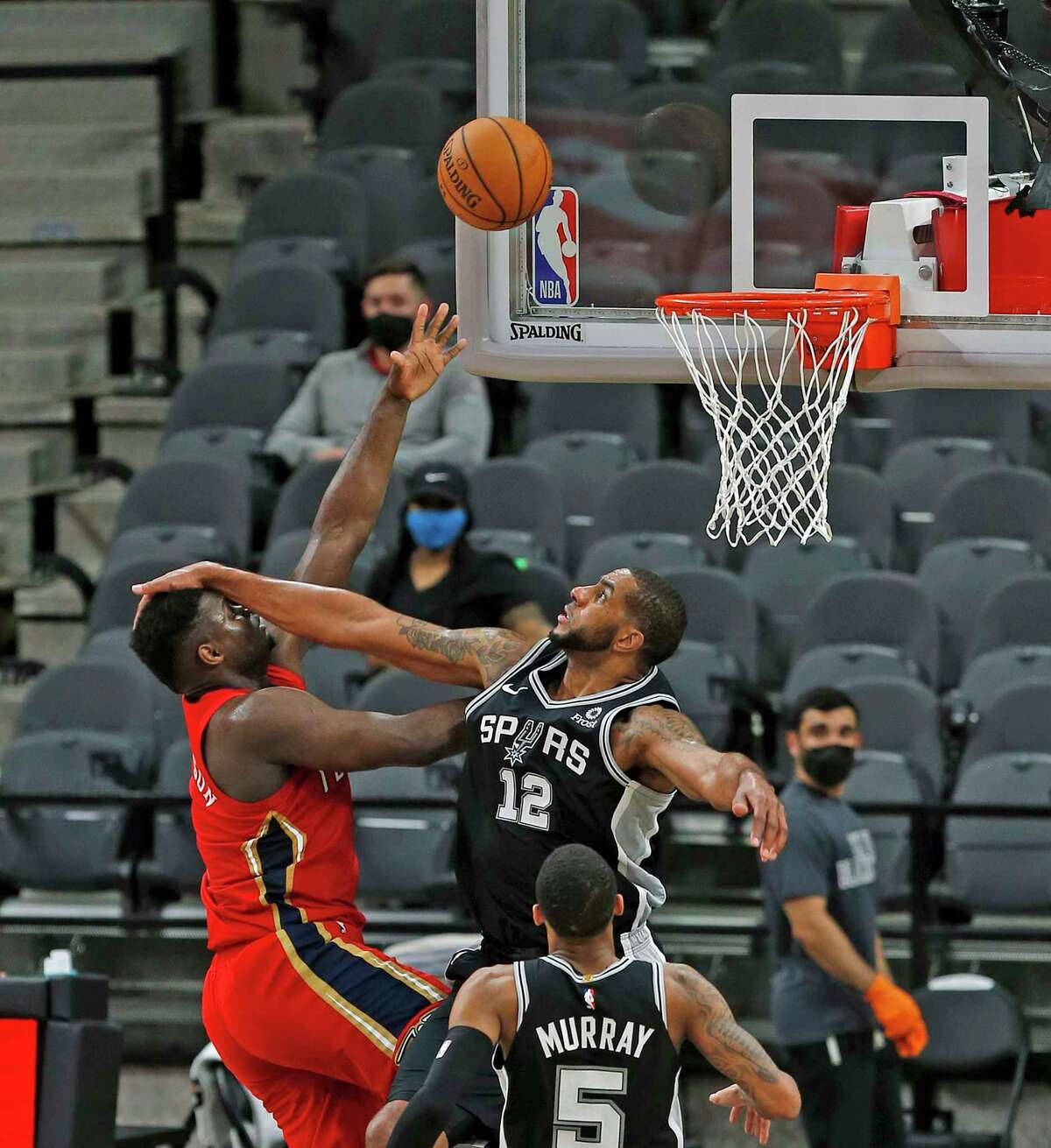 SAN ANTONIO, TX - FEBRUARY 27: LaMarcus Aldridge #12 of the San Antonio Spurs fouls Zion Williamson #1 of the New Orleans Pelicans in the first half at AT&T Center on February 27, 2021 in San Antonio, Texas. NOTE TO USER: User expressly acknowledges and agrees that , by downloading and or using this photograph, User is consenting to the terms and conditions of the Getty Images License Agreement. (Photo by Ronald Cortes/Getty Images)
