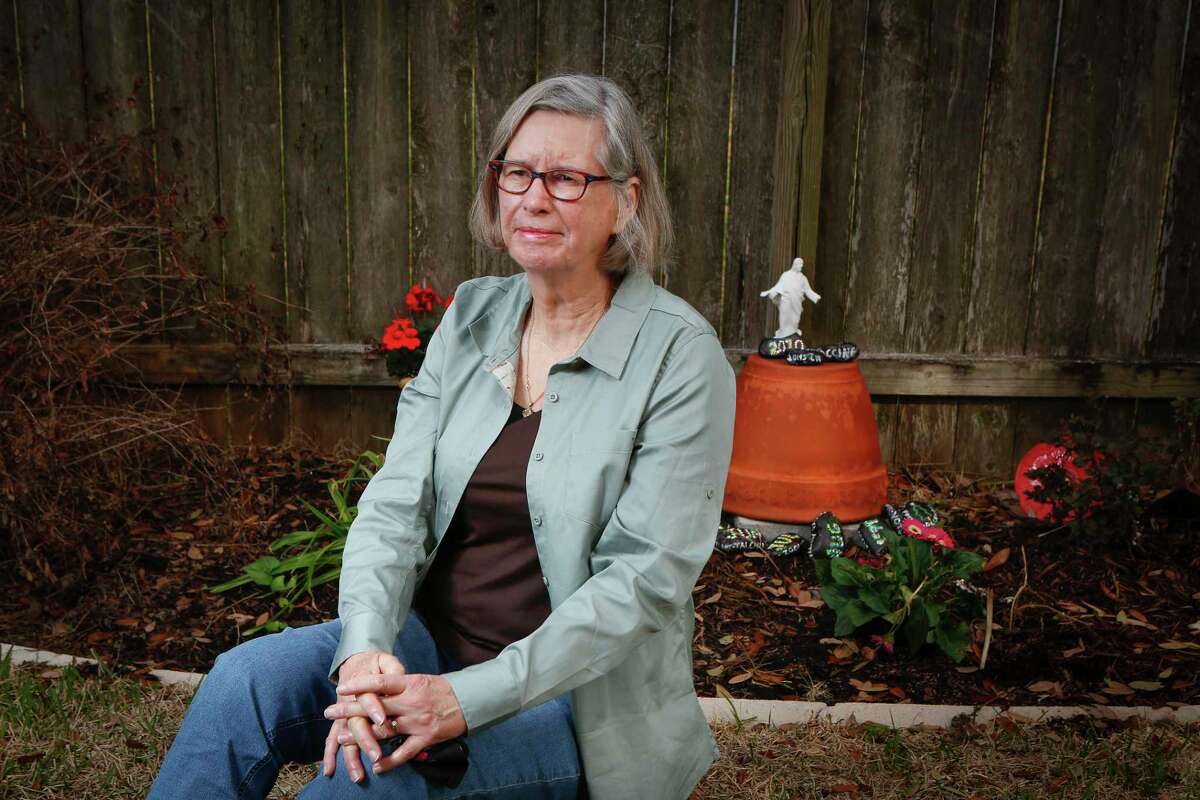 Sandy Dwyer sits in front of her memorial garden Thursday, March 11, 2021, in Houston.