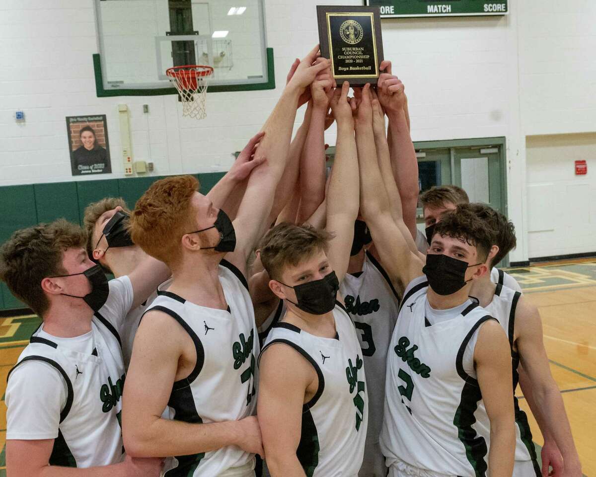 The Shenendehowa basketball team hoists the Suburban Council championship plaque after beating Troy in the title game at Shenendehowa High School in Clifton Park, NY, on Friday, March 12, 2021 (Jim Franco/special to the Times Union.)