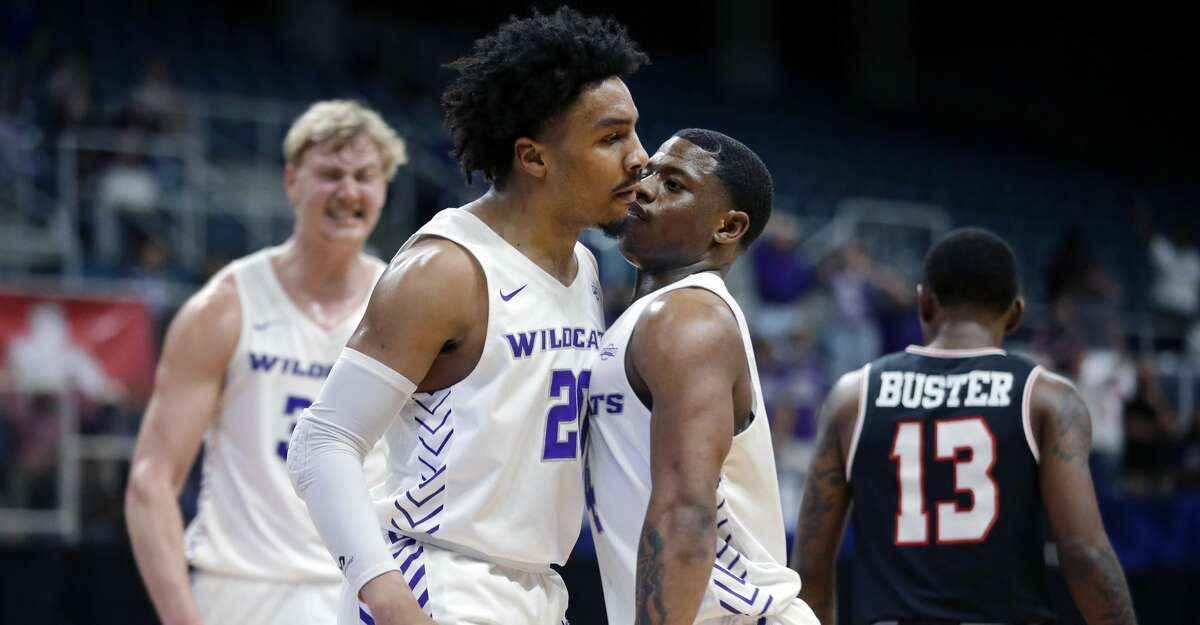 Abilene Christian guard Coryon Mason (20) and guard Damien Daniels, right, chest-bump after Mason was fouled on a dunk against Lamar during the first half of an NCAA college basketball game in the Southland Conference semifinals Friday, March 12, 2021, in Katy, Texas. (AP Photo/Michael Wyke)