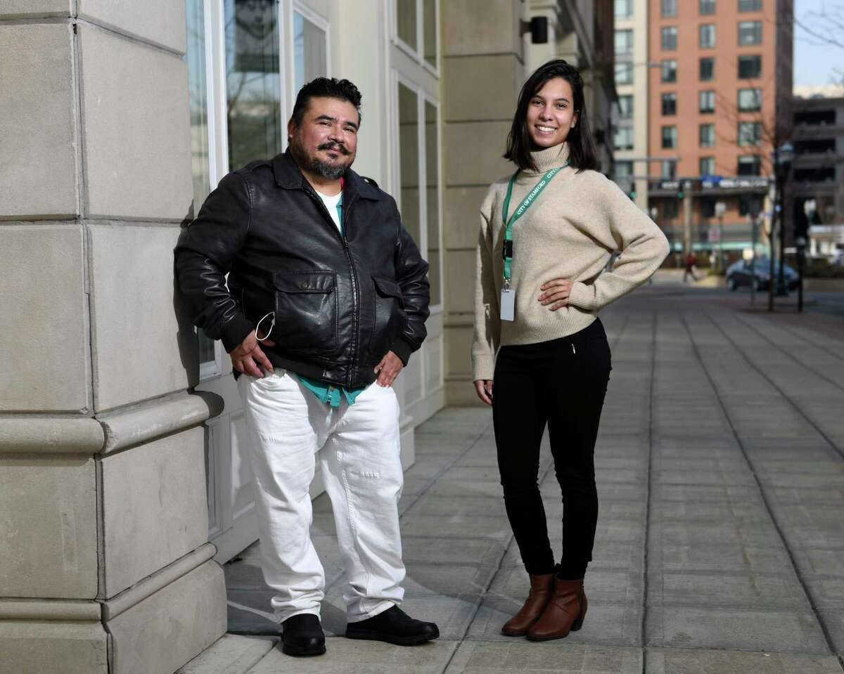 Community Health Worker Adriana Rosario and client Jose Lopez pose outside the Government Center in Stamford, Conn. Thursday, March 11, 2021. The City of Stamford and Family Centers partnered to put "boots on the ground" by creating a team of Community Health Workers to help underserved populations recovering from COVID-19. Rosario noticed Lopez was in bad shape when dropping off supplies for him and insisted that he receive medical attention for his dangerously low blood oxygen level. Without the intervention of Community Health Workers, Lopez' condition may have gone undetected.
