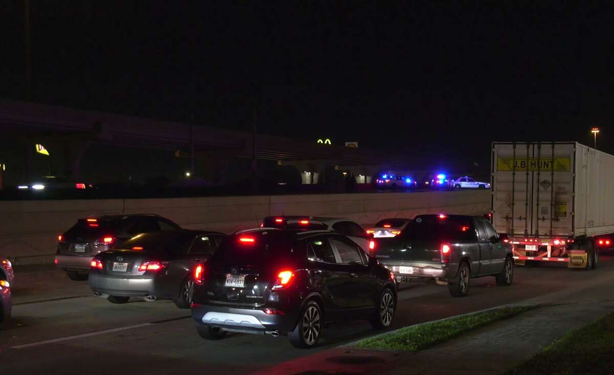 Cars move along I-45 near the I-610 interchange on Houston's southeast side after a vehicle hit a pedestrian walking on the highway.