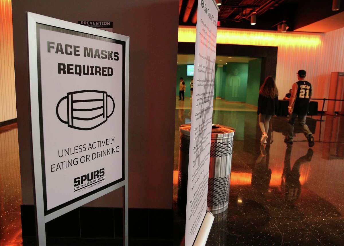 Signage is posted to remind fans to wear masks before the Spurs game against the Orlando Magic at the AT&T Center on Friday, Mar. 12, 2021. This was the first game since the start of the Covid-19 pandemic that fans were allowed to watch a game in person.