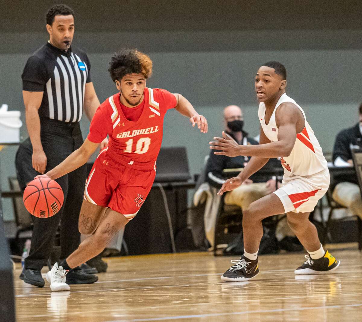 Caldwell's Ty-Shon Pannell drives around Dominican's Joshuel White in a NCAA Division II basketball regional game Saturday, March 13, 2021, at the Albany Capital Center. (Robert Simmons/ACC)