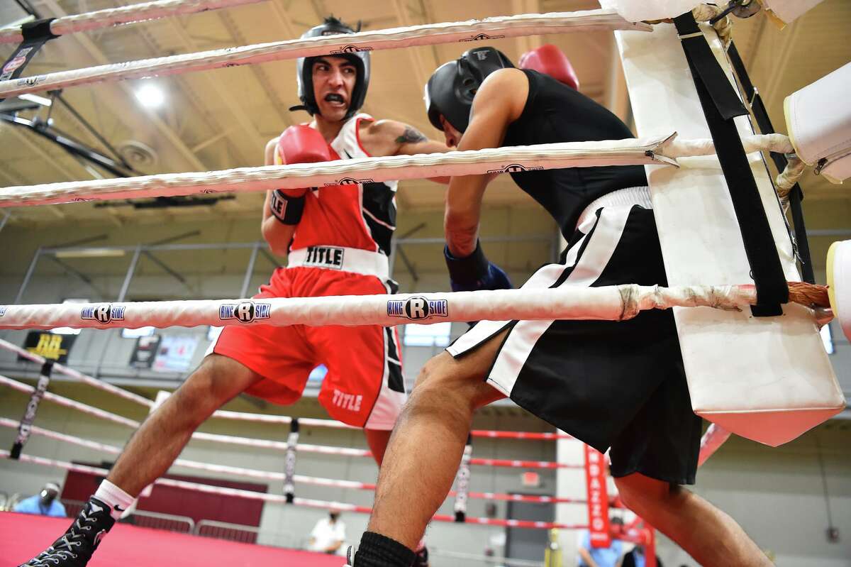 San Antonio’s Joseph Hernandez fights Mark Rodriguez during the finals of the San Antonio Regional Golden Gloves tournament on Saturday at the George Gervin Wellness Center.