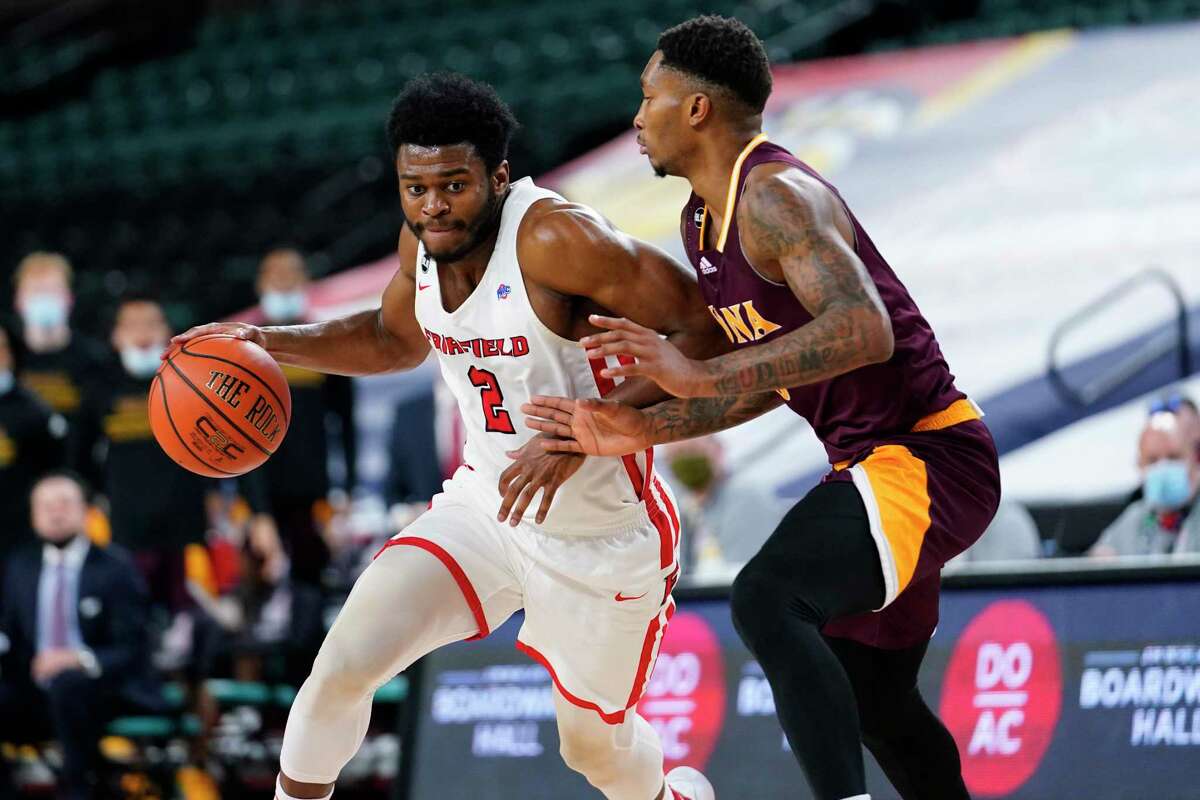 Fairfield's Taj Benning, left, dribbles past Iona's Berrick JeanLouis in the second half of an NCAA college basketball game during the finals of the Metro Atlantic Athletic Conference tournament, Saturday, March 13, 2021, in Atlantic City, N.J.
