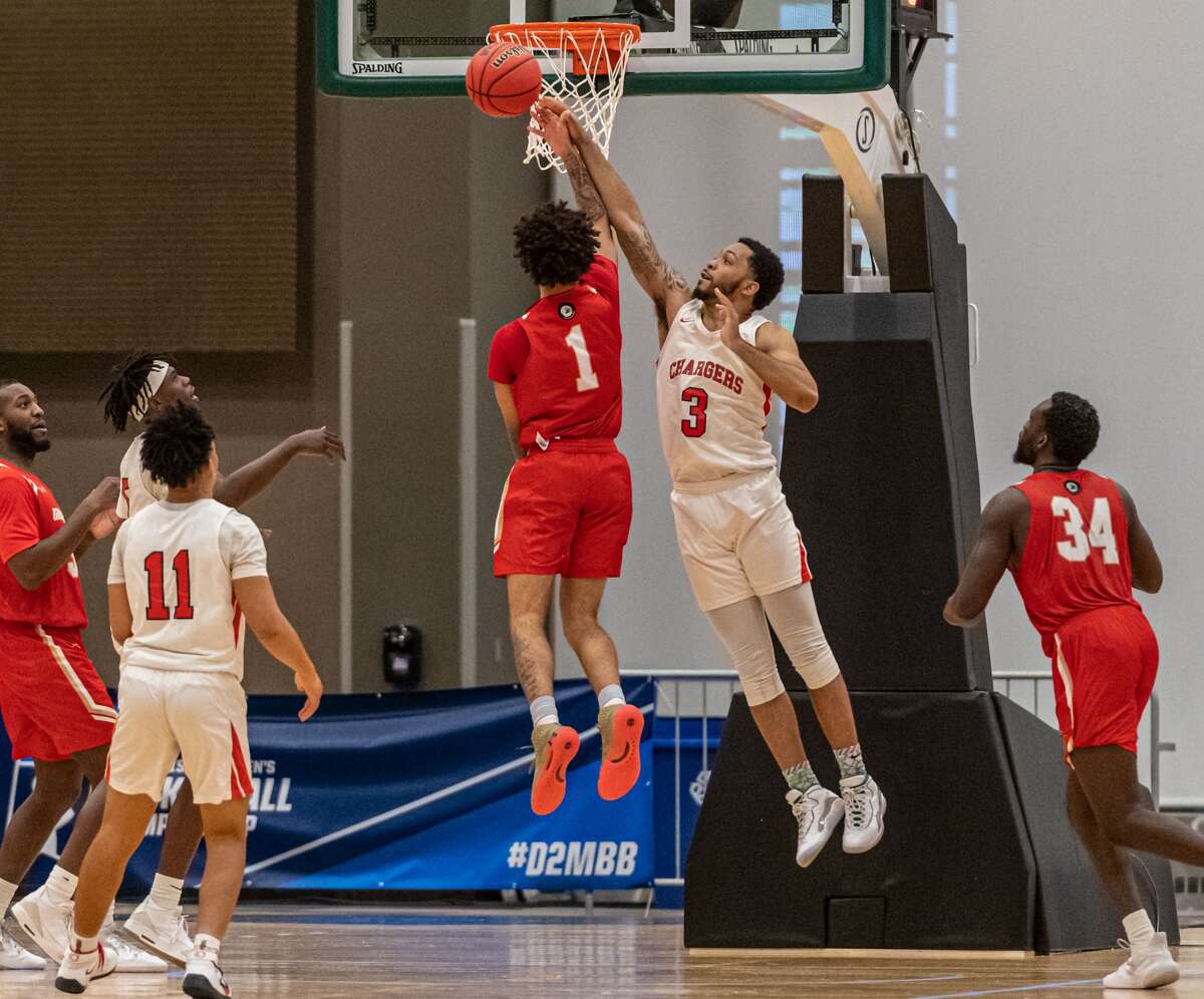 Dominican's Brandt Roundtree swats away a shot by Caldwell's Anthony Cooper in a NCAA Division II basketball regional game Saturday, March 13, 2021, at the Albany Capital Center. (Robert Simmons/ACC)