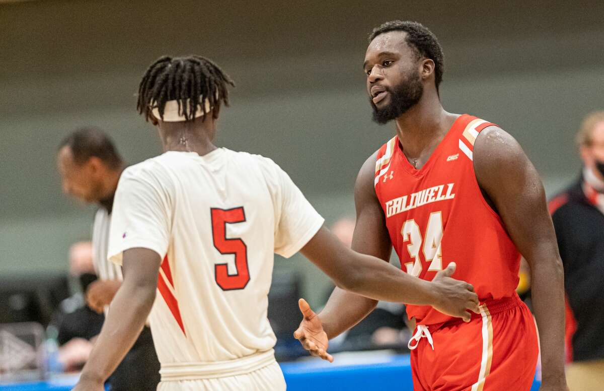 Dominican's Daniel Dade Jr. (5) congratulates Caldwell's Manley Dorme after a NCAA Division II basketball regional game Saturday, March 13, 2021, at the Albany Capital Center. Caldwell defeated Dominican, 65-62. (Robert Simmons/ACC)