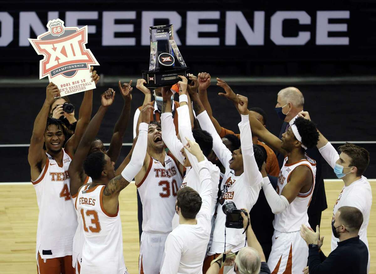 Texas players rejoice after beating Oklahoma State in Saturday’s Big 12 tournament final.