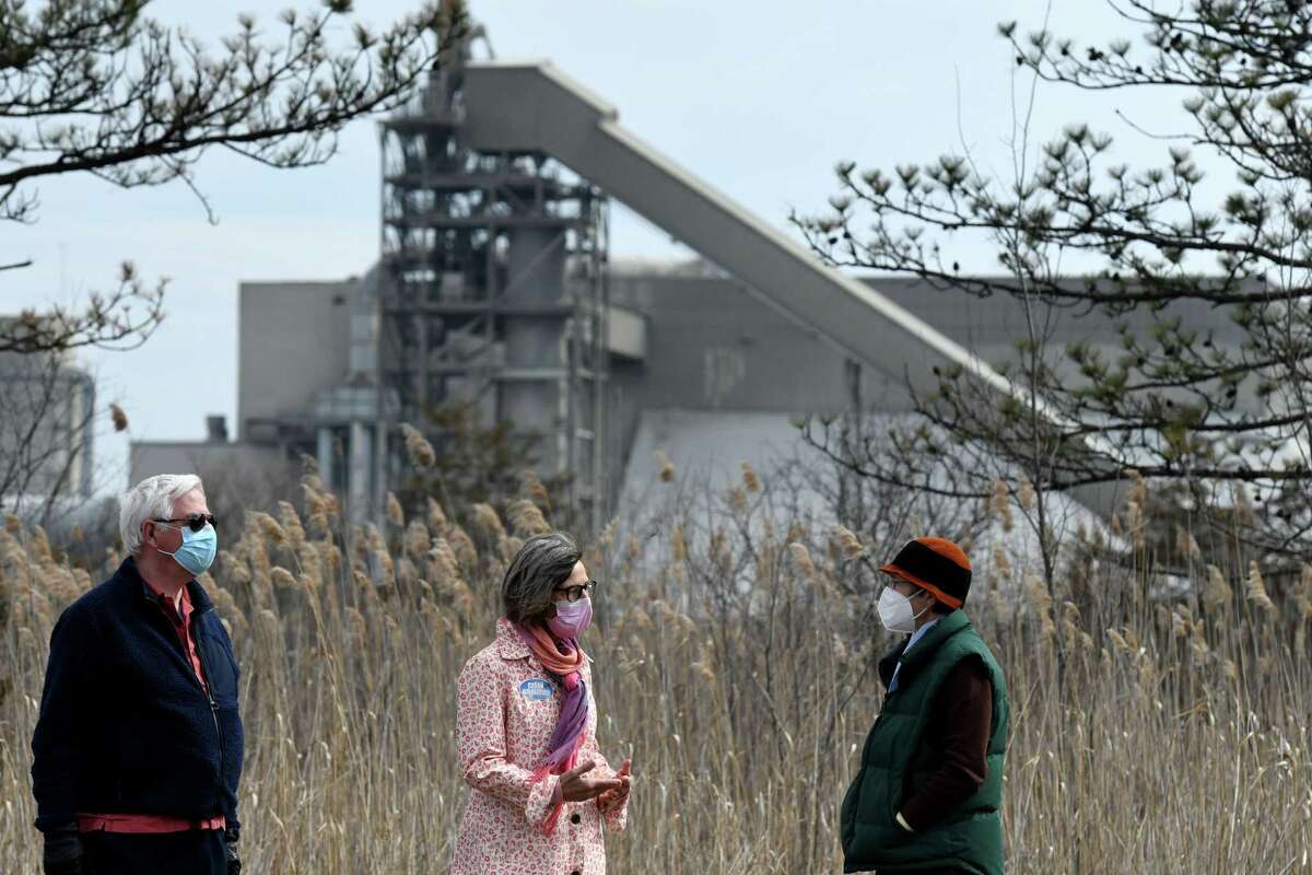 Clean Air Coalition of Greater Ravena and Coeymans members; Ray Kottke, left, Christine Primomo, center, and Barbara Heinzen, right, stand within view of the LafargeHolcim cement plant on Route 9W on Thursday, March 11, 2021, in Ravena, N.Y. The state said a sample of residue that had been settling around Ravena in fall 2021 revealed it was salt-based. The cement plant had set up a complaint form for residents - without taking responsibility for the dust. (Will Waldron/Times Union)