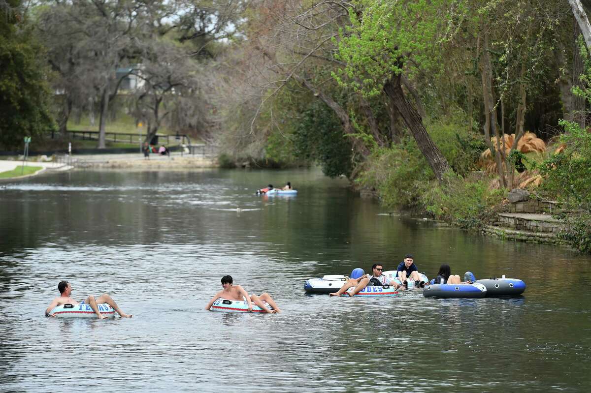 People cruise the Comal River in New Braunfels in March, when tubing season began. Heavy rains overnight spurred New Braunfels Police Department to close the Comal River on Saturday.