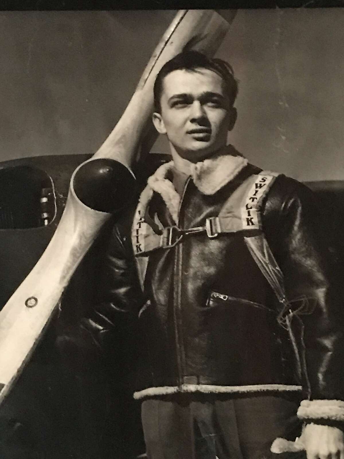 Paratrooper Glenn Atkinson with his plane during World War II.