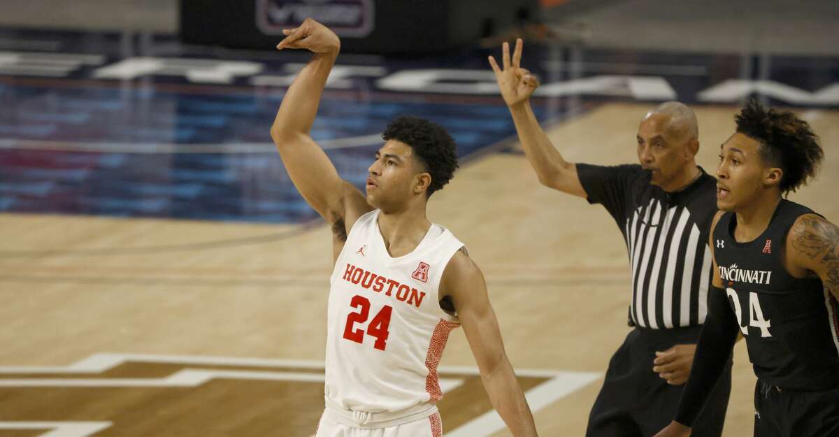 Houston guard Quentin Grimes (24) attempts a 3-point shot as Cincinnati guard Jeremiah Davenport (24) looks on during the first half of an NCAA college basketball game in the final round of the American Athletic Conference men's tournament Sunday, March 14, 2021, in Fort Worth, Texas. (AP Photo/Ron Jenkins)
