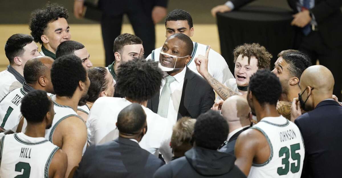 Cleveland State head coach Dennis Gates celebrates with his team an NCAA college basketball game in the men's Horizon League conference tournament championship game against Oakland, Tuesday, March 9, 2021, in Indianapolis. Cleveland State won 80-69 (AP Photo/Darron Cummings)