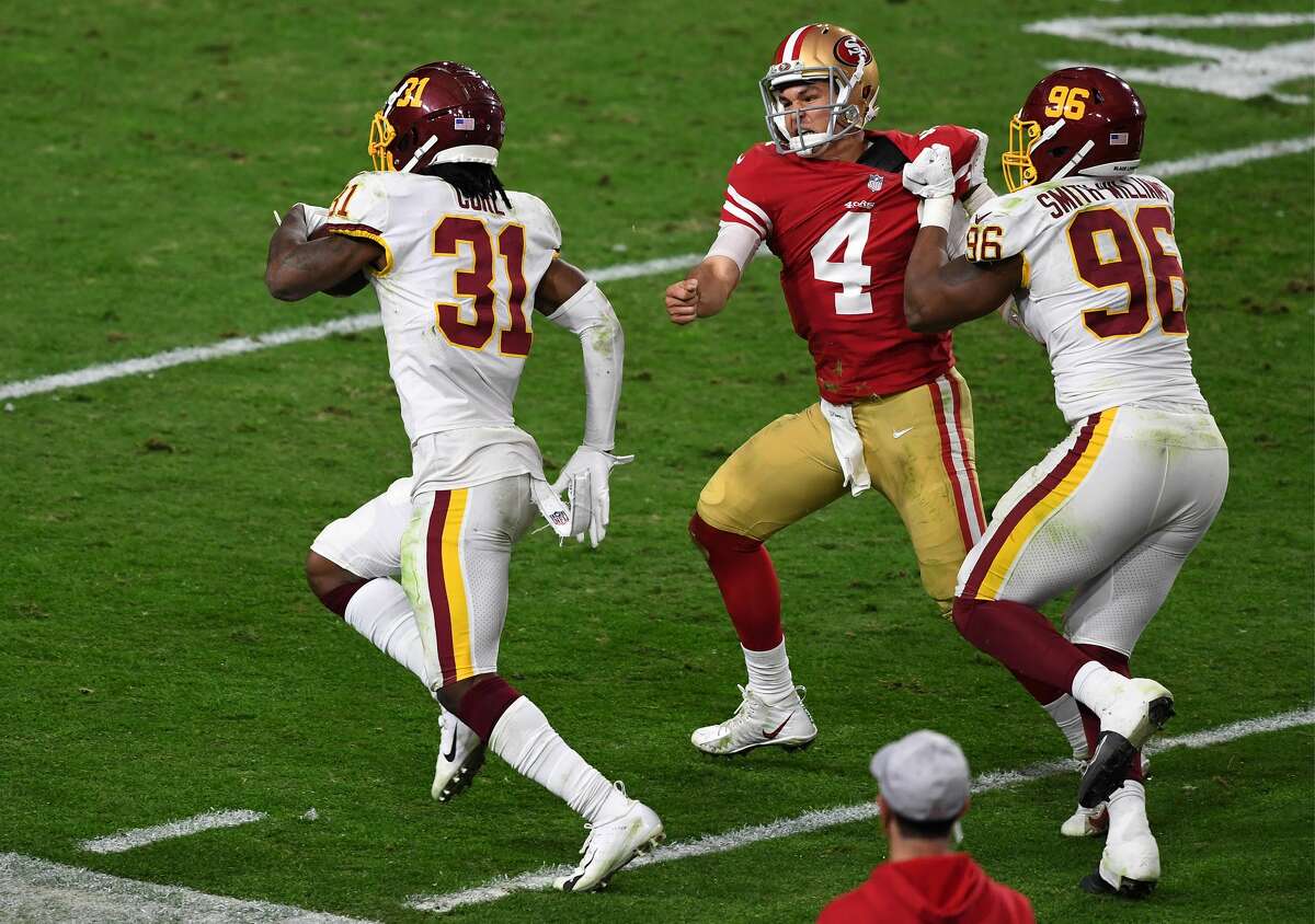 Strong safety Kamren Curl of the Washington Football Team runs for a touchdown on an interception thrown by quarterback Nick Mullens of the San Francisco 49ers on Dec. 13, 2020.