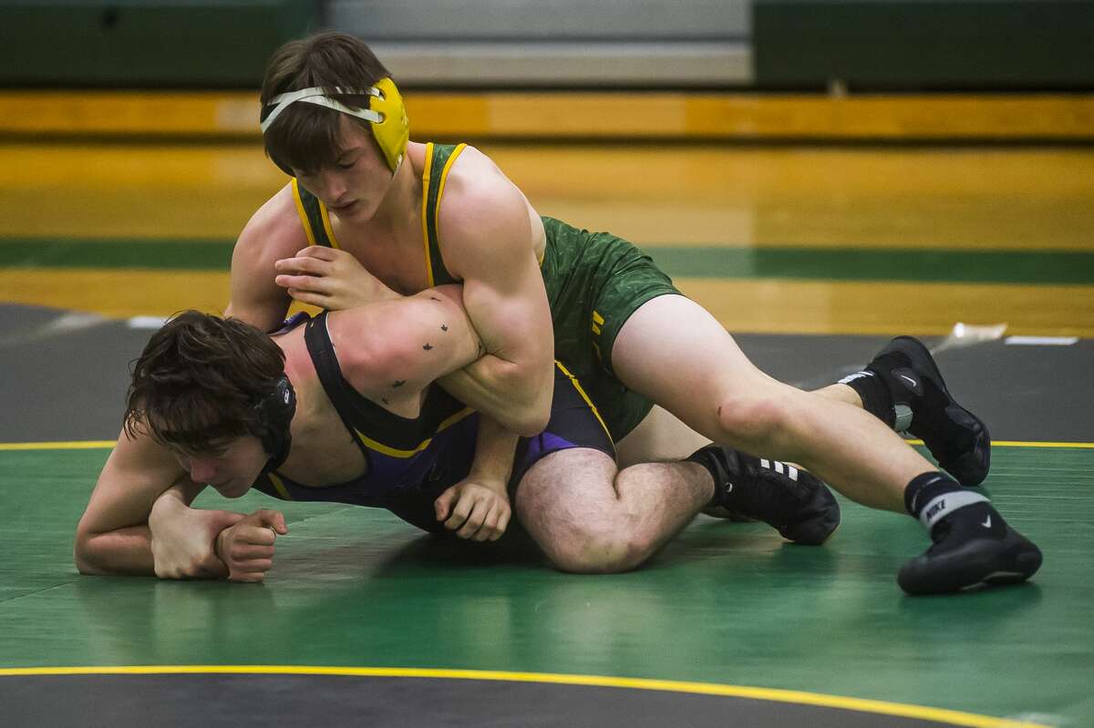 Dow High's Aidan Wardell (top) wrestles an opponent from Bay City Central in a Dec. 18, 2019 match.