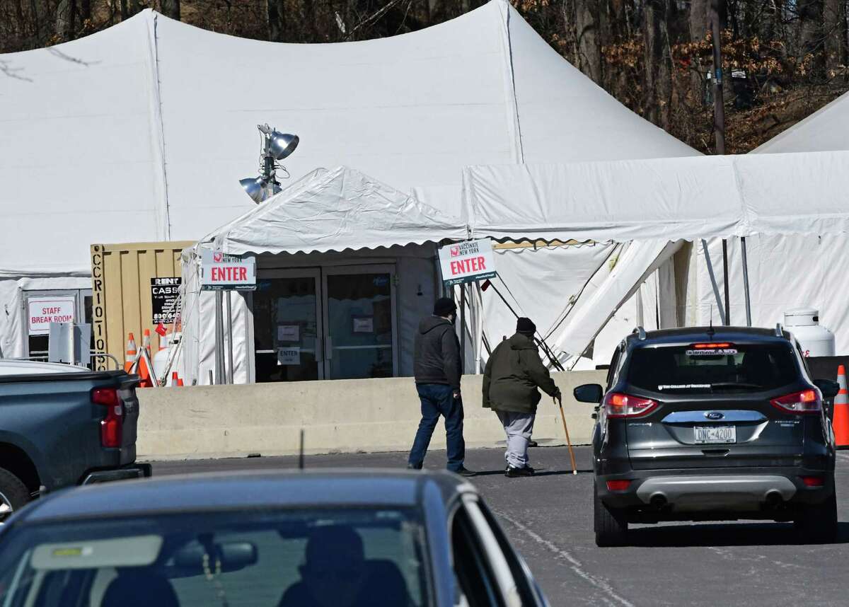 People are seen walking to the vaccination site set up at University at Albany to receive the COVID-19 vaccination on Monday, March 15, 2021 in Albany, N.Y. (Lori Van Buren/Times Union)