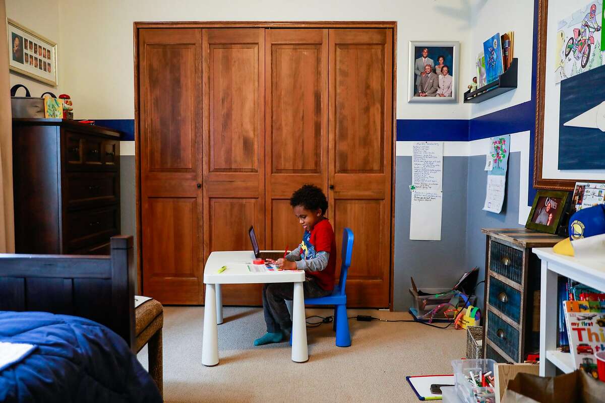 Malchester Brown IV, 6, paints a rainbow for part of his online schoolwork at his home on Monday, March 15, 2021 in Oakland.