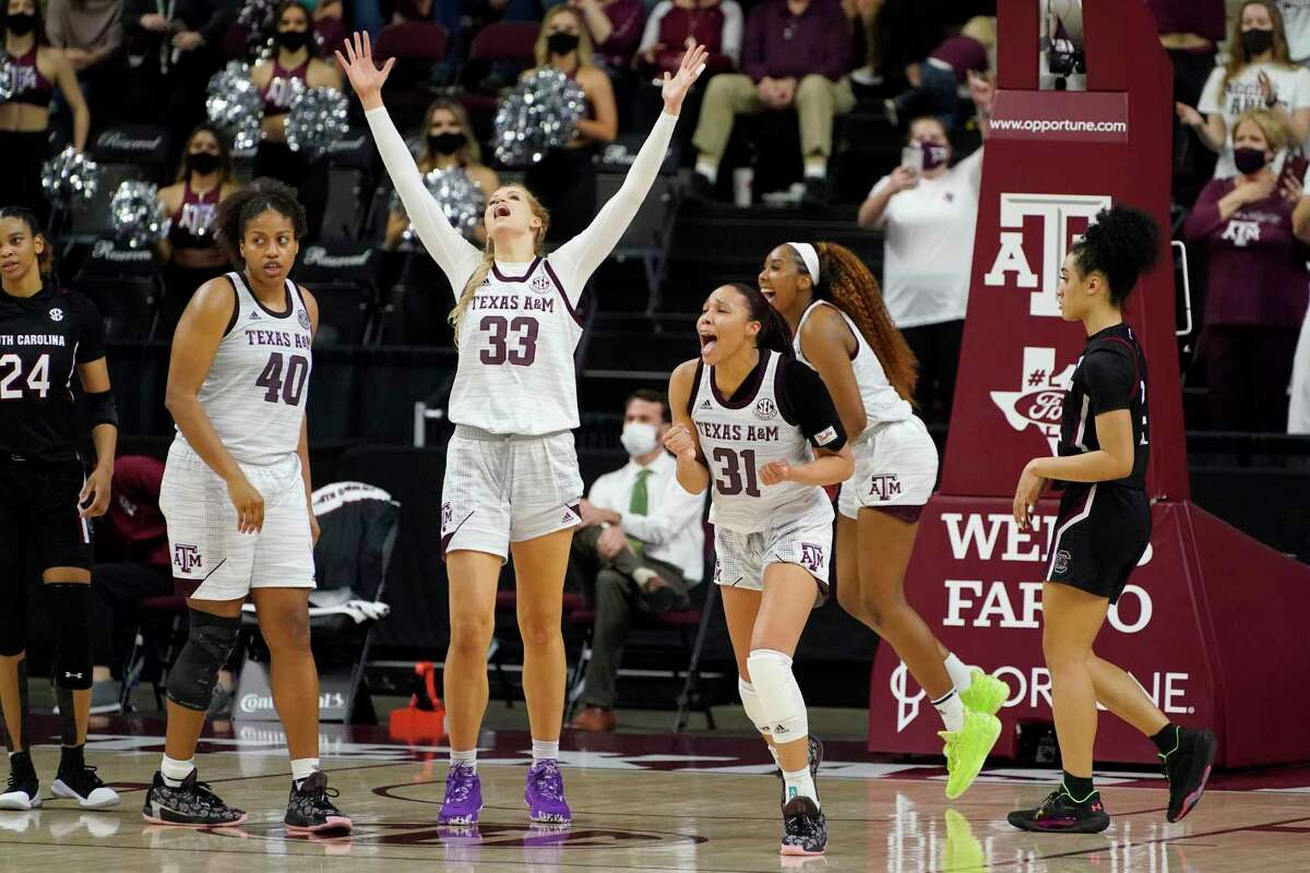 Texas A&M center Anna Dreimane (33) and forward N'dea Jones (31) react after time expires on a win during an NCAA college basketball game against South Carolina securing the Aggies first SEC regular-season championship on Sunday, Feb. 28, 2021, in College Station, Texas. (AP Photo/Sam Craft)