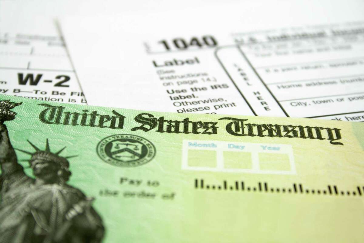 A file photo of a tax return check with some tax forms.
